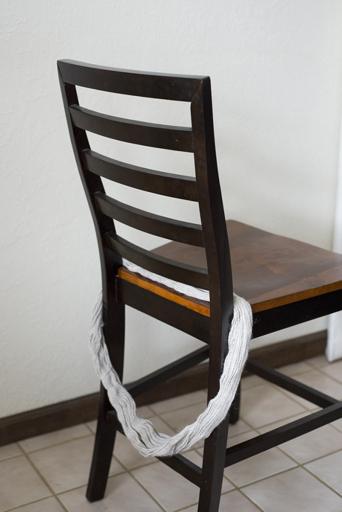 Use a dining room chair to help avoid tangle when winding a yarn hank into a yarn ball!