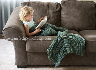 girl wearing crochet mermaid tail blanket